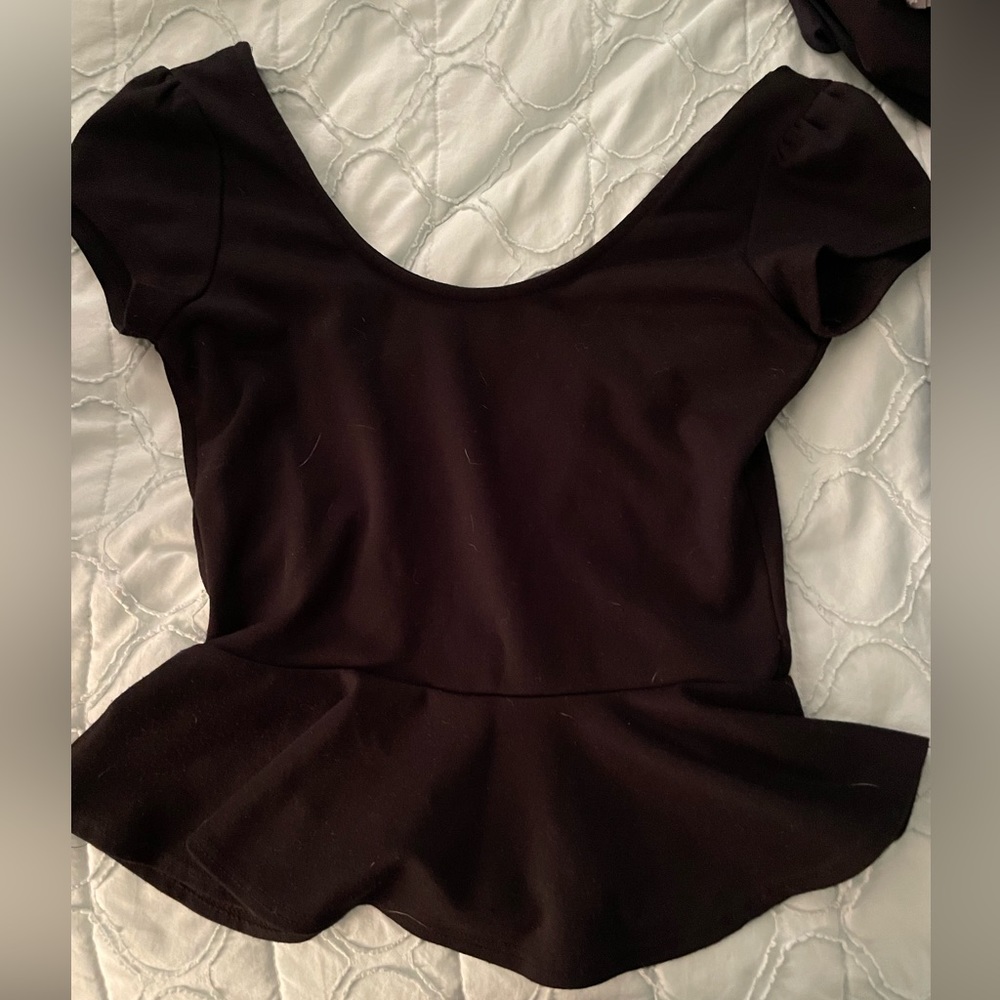 Black shirt sleeve top fitted with one flowy ruffle open back size small